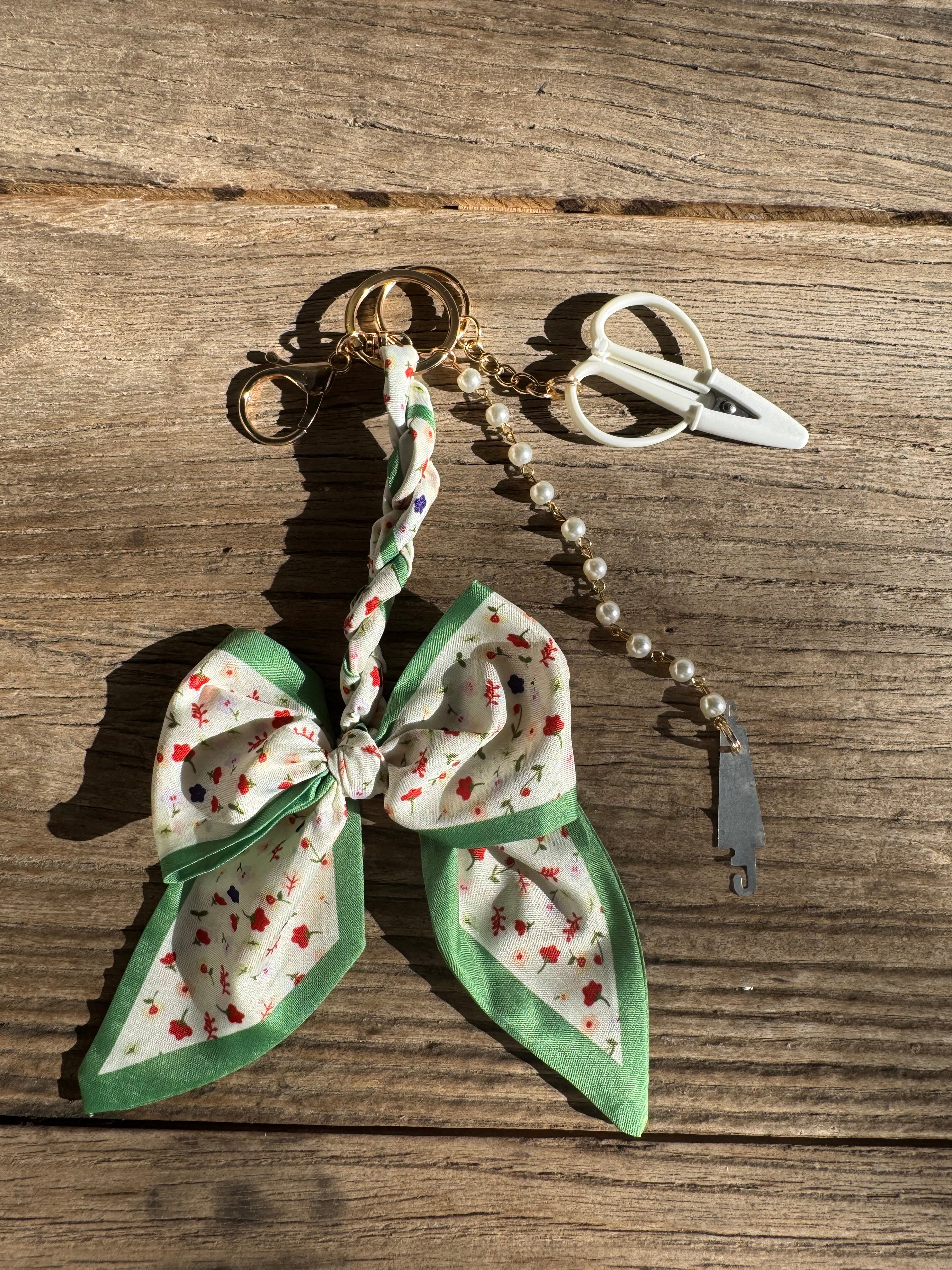 Butterfly-shaped keychain with floral design on a wooden surface
